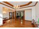 Spacious living room with hardwood floors, columns, chandeliers, and decorative trim at 1853 Water Oak Ct, Avon, IN 46123