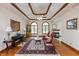 Bright living room with custom ceiling, hardwood floors, fireplace and arched windows at 1853 Water Oak Ct, Avon, IN 46123