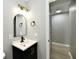 Stylish bathroom with a modern vanity, ample lighting, and wood look floors at 1965 Churchill Rd, Franklin, IN 46131