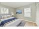 Bright bedroom with light gray walls, wood floors, and simple decor at 1965 Churchill Rd, Franklin, IN 46131
