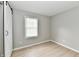 Clean, vacant bedroom with light gray walls, wood floors, and natural light at 1965 Churchill Rd, Franklin, IN 46131