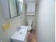 Compact bathroom featuring a vanity, toilet, medicine cabinet and neutral color scheme at 2109 N Janney Ave, Muncie, IN 47304