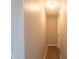 Narrow hallway features wood-style floors, light gray walls, and a doorway at the end at 2109 N Janney Ave, Muncie, IN 47304