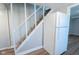 Hallway with stairway and modern refrigerator offering a functional space with easy access to multiple floors at 2109 N Janney Ave, Muncie, IN 47304
