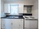 Efficient kitchen with white cabinets, black countertops, and modern appliances provides a functional workspace at 2109 N Janney Ave, Muncie, IN 47304