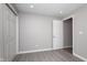 This is a bedroom with light grey walls, a light wood floor, and a white door at 217 W 35Th St, Indianapolis, IN 46208