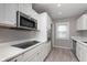 Bright kitchen features white cabinets, stainless steel appliances, and modern countertops at 217 W 35Th St, Indianapolis, IN 46208