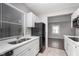 View of kitchen with stainless steel sink and black refrigerator, and view to another room at 217 W 35Th St, Indianapolis, IN 46208