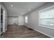 Spacious living room featuring wood floors, neutral paint and abundant natural light from large windows at 217 W 35Th St, Indianapolis, IN 46208