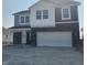 Charming two-story home showcasing a brick and vinyl exterior with an attached two car garage at 2209 Boxwood Dr, Greenfield, IN 46140
