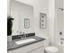Bright bathroom features a tiled shower, granite countertop, and decorative wall art at 2212 Foothill Dr, Greenfield, IN 46140