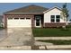 Inviting single-Gathering home featuring a manicured lawn, brick accents, and a two-car garage at 2212 Foothill Dr, Greenfield, IN 46140