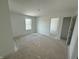 A clean, bright bedroom with ample natural light and a view into the next room at 24517 Wallace St, Sheridan, IN 46069