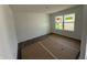 Well-lit bedroom with a large window and fresh, white paint, ready for personalization at 24517 Wallace St, Sheridan, IN 46069