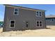 Rear view of a two-story home featuring large windows for natural lighting and gray siding at 24517 Wallace St, Sheridan, IN 46069