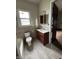 Tiled bathroom featuring vanity and sink, toilet, and bathtub at 2657 E Riverside Dr, Indianapolis, IN 46208