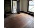 Spacious bedroom with wood floors and access to an ensuite bathroom at 2657 E Riverside Dr, Indianapolis, IN 46208