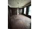 Dining room features wood-paneled walls, original hardwood floors, and vintage chandelier at 2657 E Riverside Dr, Indianapolis, IN 46208