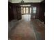 Dining room features wood-paneled walls, original hardwood floors, and vintage chandelier at 2657 E Riverside Dr, Indianapolis, IN 46208