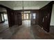 Dining room features wood-paneled walls, original hardwood floors, and vintage chandelier at 2657 E Riverside Dr, Indianapolis, IN 46208