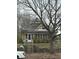 Charming home featuring brick accents, a quaint porch, and mature trees, perfect for a cozy living at 2657 E Riverside Dr, Indianapolis, IN 46208