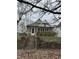 Charming home featuring brick accents, a quaint porch, and mature trees, perfect for a cozy living at 2657 E Riverside Dr, Indianapolis, IN 46208