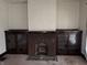 Living room featuring a brick fireplace flanked by built-in cabinets with leaded glass doors at 2657 E Riverside Dr, Indianapolis, IN 46208