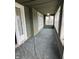 Enclosed porch with green walls and carpet features multiple windows, offering a bright and airy space at 2657 E Riverside Dr, Indianapolis, IN 46208