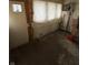 The shed features a door, window, electrical panel, and unfinished walls, perfect for storage at 2657 E Riverside Dr, Indianapolis, IN 46208