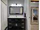 Bathroom featuring a modern vanity with a black cabinet, white countertop, and a rectangular mirror at 2979 Amherst St, Indianapolis, IN 46268