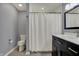 Bathroom featuring a modern vanity with a black cabinet and a shower with a white curtain at 2979 Amherst St, Indianapolis, IN 46268