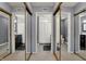 Bathroom featuring three mirrored sliding doors, leading to a toilet and black vanity at 2979 Amherst St, Indianapolis, IN 46268