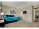 Bedroom featuring daybed with teal pillows and view to sitting room with leather couch at 2979 Amherst St, Indianapolis, IN 46268