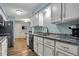Charming kitchen features white cabinetry, stainless appliances, and wood floors at 2979 Amherst St, Indianapolis, IN 46268