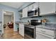 Efficient kitchen offers stainless appliances, white cabinets, and wood floors at 2979 Amherst St, Indianapolis, IN 46268