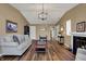Open living room with hardwood floors, a fireplace, and seamless access to other rooms at 2979 Amherst St, Indianapolis, IN 46268