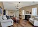 Cozy living room featuring hardwood floors, a fireplace, and comfortable seating arrangements at 2979 Amherst St, Indianapolis, IN 46268