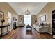 Spacious living room with hardwood floors, a fireplace, and large windows for natural light at 2979 Amherst St, Indianapolis, IN 46268