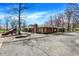 Community clubhouse and playground with mature trees, a playground, and picnic tables at 2979 Amherst St, Indianapolis, IN 46268