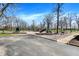 A community playground with swings, slide, benches, and a tennis court creates a fun recreation space at 2979 Amherst St, Indianapolis, IN 46268