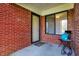 Inviting front porch features a brick wall, a cozy chair, and a welcoming entrance at 2979 Amherst St, Indianapolis, IN 46268
