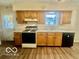 Efficient kitchen layout with wood cabinets and modern appliances at 301 Barton Ave, Indianapolis, IN 46241