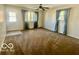 Bright living room with large windows, neutral walls, and comfortable carpeting at 301 Barton Ave, Indianapolis, IN 46241
