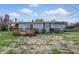 Backyard featuring a deck, sliding glass door, and mature bushes at 318 Camby St, Greenwood, IN 46142