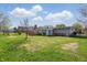 Large backyard featuring mature landscaping and outdoor deck at 318 Camby St, Greenwood, IN 46142