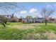 Lush backyard view with a wooden deck and partial fence at 318 Camby St, Greenwood, IN 46142