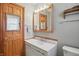Bathroom featuring white vanity, medicine cabinet, and wood-framed mirror at 318 Camby St, Greenwood, IN 46142