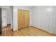 Bedroom features hardwood flooring, closet, and neutral wall paneling at 318 Camby St, Greenwood, IN 46142