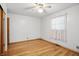 White bedroom with hardwood floors and lace-trimmed window at 318 Camby St, Greenwood, IN 46142