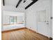 Dining area featuring hardwood floors, beamed ceilings, and access to the backyard at 318 Camby St, Greenwood, IN 46142